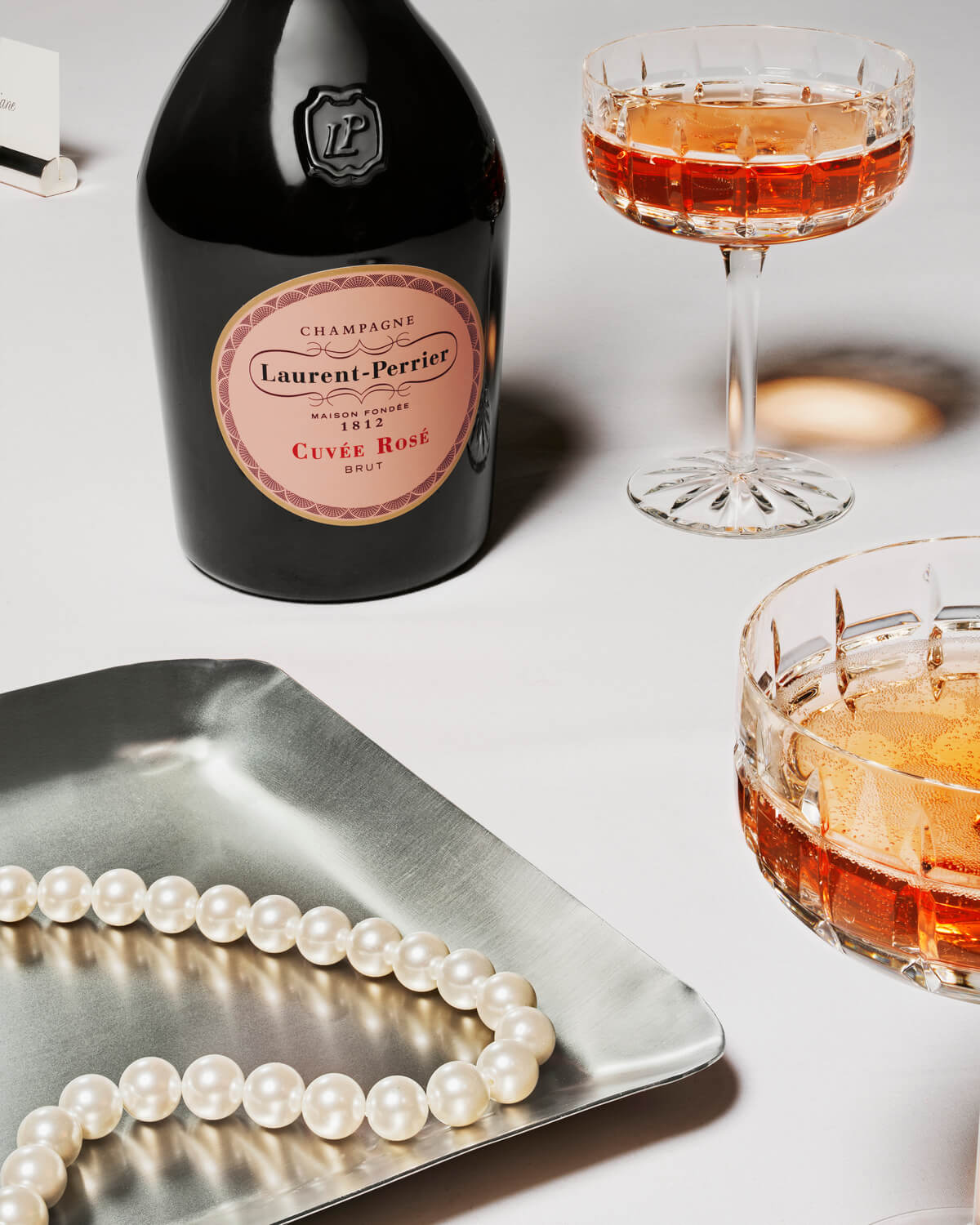 rosé cuvée pearl necklace champagne coupes